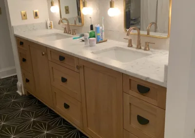 A bathroom with two sinks and a mirror.