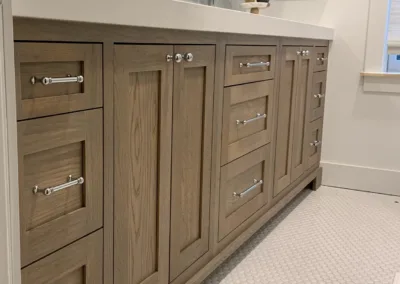 A bathroom with wooden cabinets and a mirror.