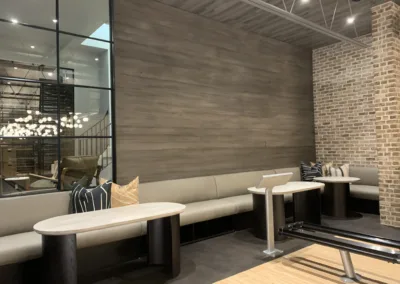 A gym with benches and a brick wall.