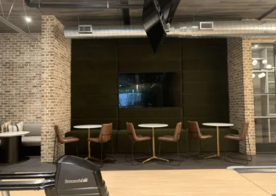 An office with a bowling alley and tables.