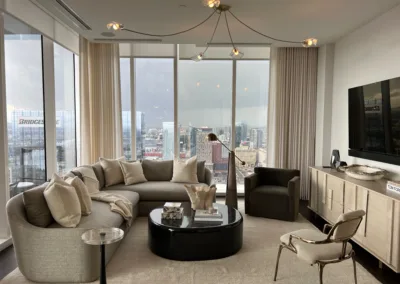 A living room with large windows overlooking a city.