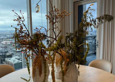 A table with vases on it and a view of the city.