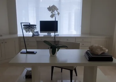 A white home office with an arched window.