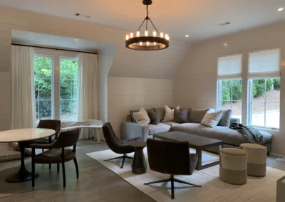A living room with white walls and a chandelier.
