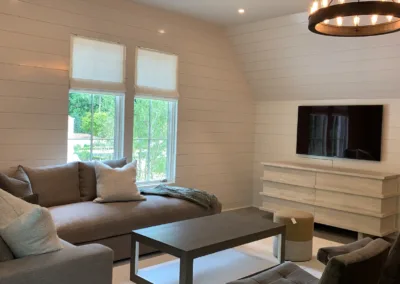 A living room with a gray couch and tv.