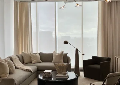 A living room with a large sectional couch and a coffee table.